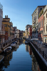 Fototapeta na wymiar Narrow canal in Venice on a summer morning