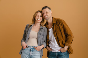 White happy couple wearing shirts smiling and looking at camera
