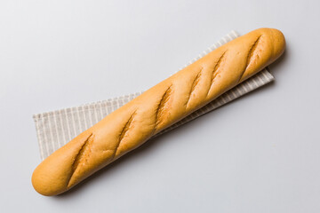 fresh crunchy french baguette on colored table. Top view Bakery products
