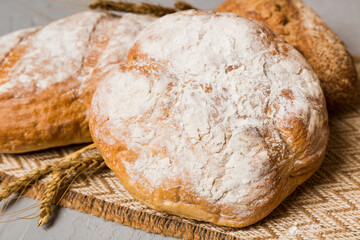 Homemade natural breads. Different kinds of fresh bread as background, perspective view with copy space