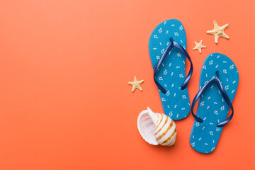 Flat lay composition with flip flops and seashell on colored background. Space for text top view