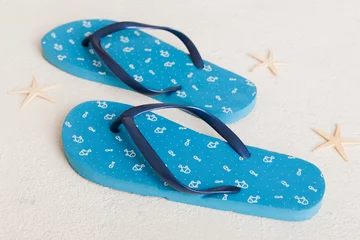 Tuinposter Beach accessories. Flip flops and starfish on colored background. Top view Mock up with copy space © sosiukin