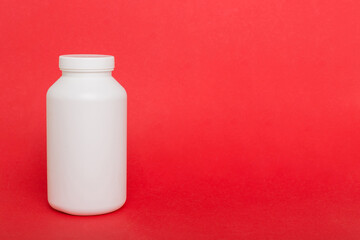 supplement pills with medicine bottle health care and medical top view. Vitamin tablets. Top view mockup bottle for pills and vitamins with green leaves, natural organic bio supplement, copy space