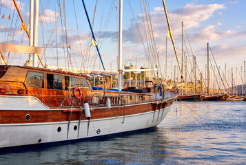Group of boats docked in a harbor of Bodrum in Turkey at sunset. Scenic view of sailing yachts in...