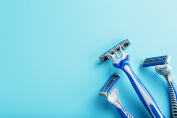 Blue shaving machines in a row on a blue background with ice cubes