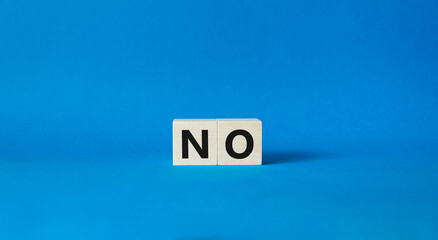 No symbol. Concept words No on wooden blocks. Beautiful blue background. Business and No concept. Copy space.