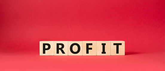 Profit symbol. Concept word Profit on wooden cubes. Beautiful red background. Business and Profit concept. Copy space.