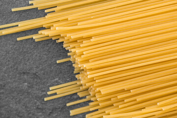 Spaghetti pasta isolated on dark, from above