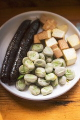 Broad beans with dill and butter with black pudding sausage 