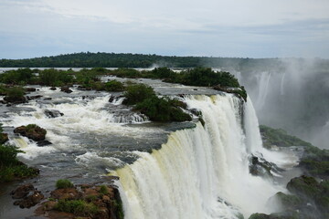 The photo shows a stunning view from the top of the Iguazu Falls — a complex of 275 waterfalls on the Iguazu River, located on the border of Brazil and Argentina.