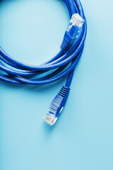 A coil of an Internet network cable for data transmission on a blue background