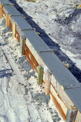 Timber formwork with metal reinforcement for pouring concrete and creating a solid foundation for a building or sauna. Construction process.