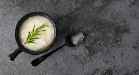 Yoghurt in bowl and spoon  on the table