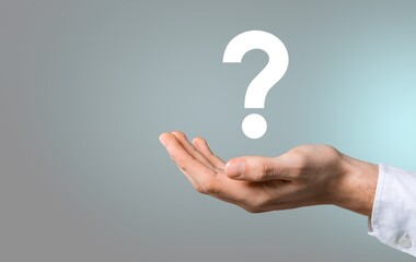 businessman hand holding question mark. concept of Question mark and FAQs, Ask quiestion online