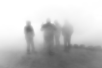 group of people together in heavy fog