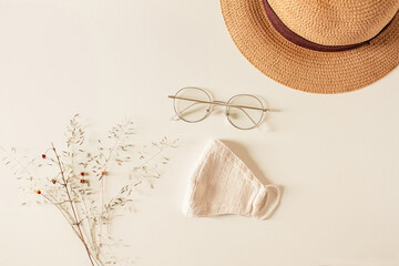 Travel concept. Composition with eyeglasses, hat and mask on a white background. Autumn, fall mock...