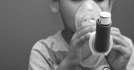 boy with hay fever inhaler on grey background stock photo