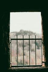 Inside view of a castle window with metal fence.