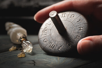 Zodiac horoscope wheel in the astrologist hand close up.
