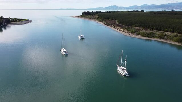 2.7K Aerial shot of boats with shallow clear water on a sunny day