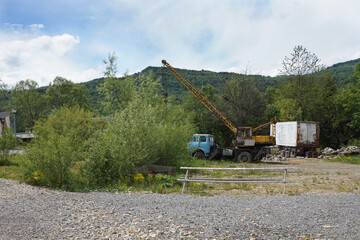 An old crane at a construction site in the mountains.   