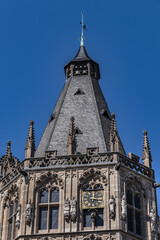 Fototapeta na wymiar Architectural details of medieval Cologne Town Hall (Rathaus Koln) - XV century Gothic style tower. Cologne, North Rhine Westphalia, Germany.