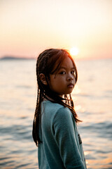 Asian Child Girl on the beach sunset 