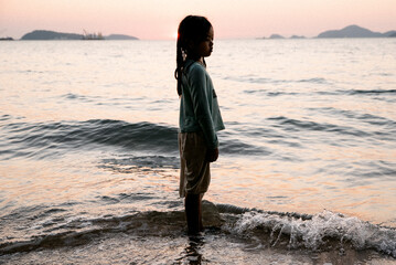 Asian Child Girl on the beach sunset 