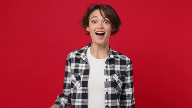 Excited fun pensive young woman 20s she wears basic white t-shirt checkered shirt looks around thinks comes up with ideas raised finger get plan isolated on plain solid dark red color wall background