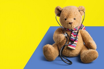 World Down Syndrome Day background. Down syndrome awareness symbol. Teddy bear on yellow and blue background.