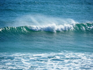 White waves crushing on blue sea