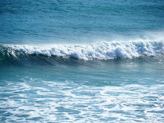 White waves crushing on blue sea