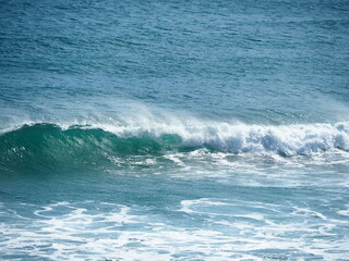 White waves crushing on blue sea