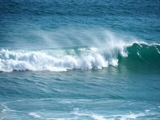 White waves crushing on blue sea