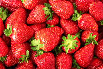 Juicy strawberry texture top view. Whole ripe yummy berries for background or wallpaper. Natural summer food concept.