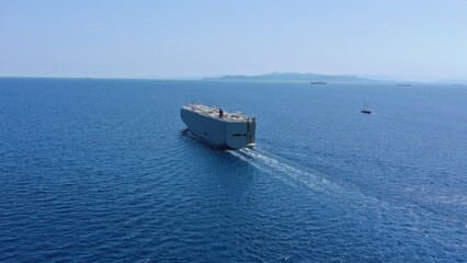 Aerial drone photo of Large RoRo (Roll on-off) car cargo ship cruising the Mediterranean deep blue sea