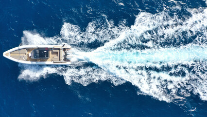 Aerial drone photo of luxury rigid inflatable speed boat cruising in high speed in Aegean deep blue sea, Greece