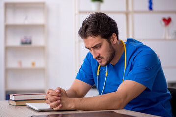 Young male doctor working in the clinic