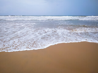 Fototapeta na wymiar Amazing view of wave of the sea on the sandy beach background