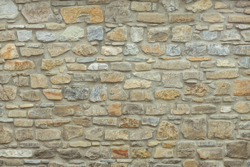 Sturdy yellow and beige cut stone wall, good for backgrounds