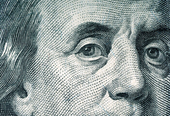 Eyes of Benjamin Franklin on a hundred dollar bill. Macro photography.
