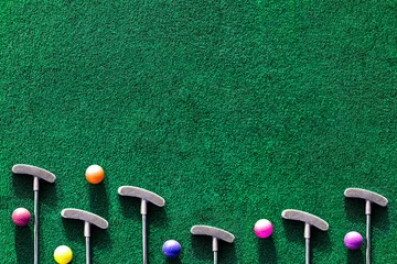 Fotobehang Multiple mini golf clubs and balls on putting green background with copy space © Julia