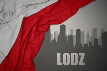abstract silhouette of the city with text Lodz near waving national flag of poland on a gray background.