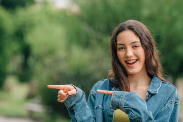 young girl pointing smiling outdoors