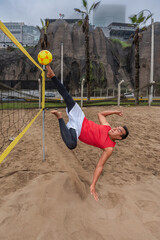Man kicking a ball in the air during a footvolley match