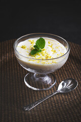 Lemon Mousse in cups, decorated with  mint . Fresh dessert.