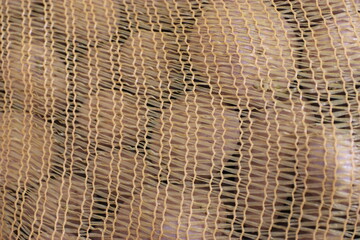 Potatoes in a mesh bag, for sale in quantities.