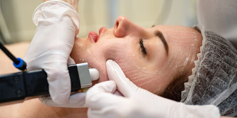 Obraz na płótnie Canvas Close up of beautiful young woman getting rejuvenation treatment in beauty salon