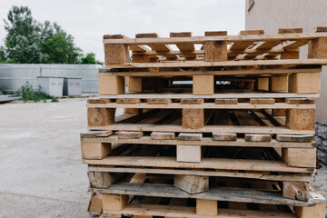 Wooden pallets lie on top of each other on the street
