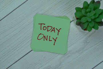 Concept of Today Only write on sticky notes isolated on Wooden Table.